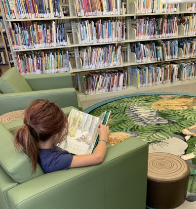 A young child reading in a Colorado Library.