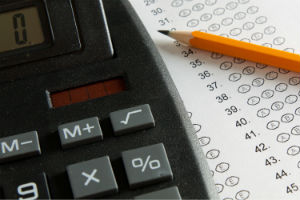 A calculator and a test answer document with circles where students indicate responses