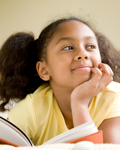 Young girl with a book, smiling and thinking