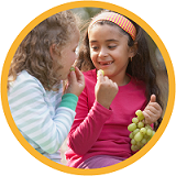 Young kids eating grapes